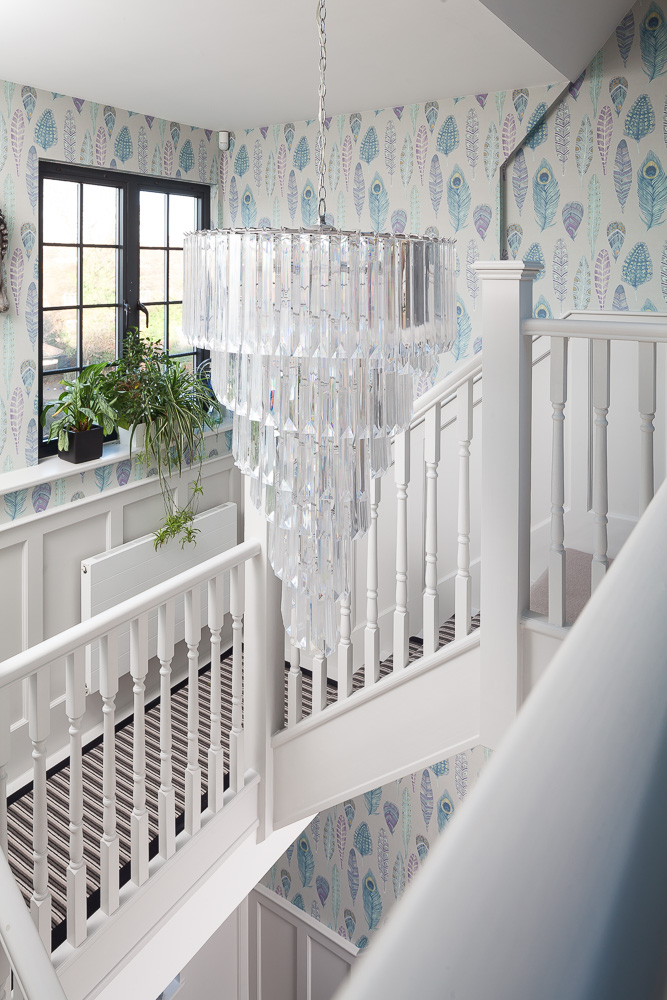 Statement chandelier on upstairs landing